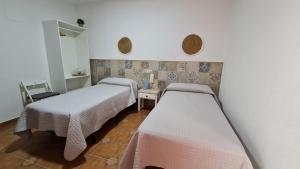 Postel nebo postele na pokoji v ubytování Hostal Canalejas