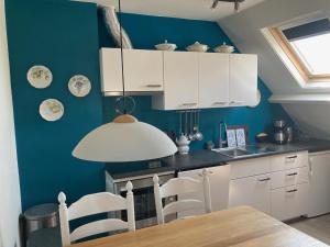 Kuchyň nebo kuchyňský kout v ubytování 'Onder-dak' 2-persoons appartement