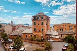 an old building in a city with cars parked at House Azzurra by Holiday World in Genova