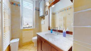 a bathroom with a sink and a toilet and a window at House Azzurra by Holiday World in Genova +8 photos