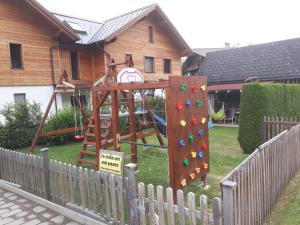 a playground in a yard next to a house at LANDHAUS JASMIN ausgezeichnet mit 4 Kristallen - FW Zinkenblick in Bad Mitterndorf