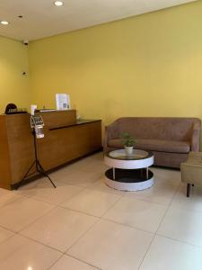 a waiting room with a couch and a table at Studio 5B with Balcony across Terminal 3 Airport in Manila