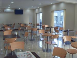 a room full of tables and chairs in a restaurant at Hotel Micro in Rosario