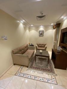 a living room with a couch and a table at Hayat Redwa Hotel in Yanbu +15 photos