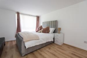 a bedroom with a large bed and a window at Sean's Pond in Shipley