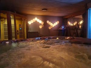 una gran bañera de hidromasaje en una habitación con luces en Le PasSionNant en Morzine