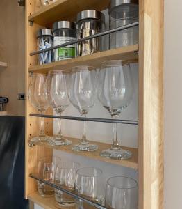 a bunch of wine glasses on a shelf at Zion Place in Dartmouth