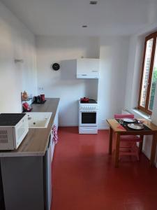 a kitchen with a counter and a table in it at Studio avec une cour. in Joigny