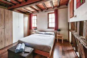 a bedroom with a bed and a table and windows at Maison de ville spacieuse et calme en plein coeur d'Amiens in Amiens +14 photos