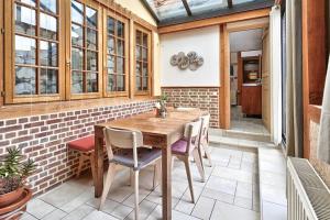 a patio with a wooden table and chairs at Maison de ville spacieuse et calme en plein coeur d'Amiens in Amiens