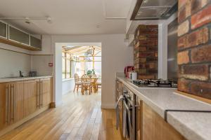 a kitchen with wooden floors and a brick wall at Sean's Pond in Shipley