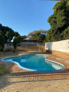 a small swimming pool in a brick yard at liam travel inn in Nelspruit