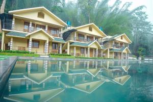 a building with its reflection in the water at Muthanga Wild Resort in Muthanga