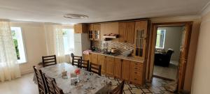 a kitchen with a table with chairs and a kitchen with a counter at Qusarda günlük kiraye əv,Guest house for the rent Shahdag Kusary in Qusar