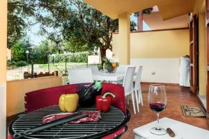 a table with a plate of food and a glass of wine at Roero Home in Rena Majore