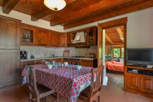 a kitchen with a table with a table cloth on it at 3 Charming Private Home with Pool, BBQ, Wi-Fi & Free Parking in Castel del Piano