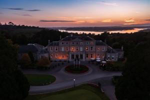 an aerial view of a building with a sunset in the background at Faithlegg Hotel in Waterford
