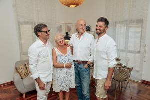 a group of three men and a woman standing in a living room at Suite 51 Luxury home in Pescara