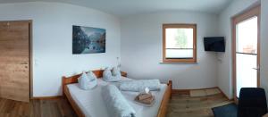 a white living room with a couch and a window at Apart Leo in Stummerberg
