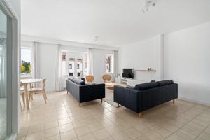 a living room with two couches and a table at - Duin 63 - Ruim 8 pers duplex app met terras in Koksijde