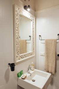 a white bathroom with a sink and a mirror at Suite 51 Luxury home in Pescara