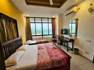 a bedroom with a bed and a desk with a piano at Suman Cottage & Bungalow in Mahabaleshwar