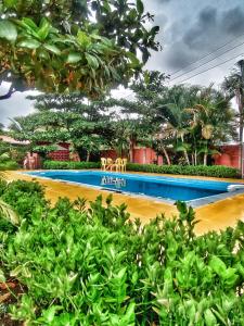 einen Pool mit zwei Stühlen in einem Resort in der Unterkunft Opulence Beach Resort Awas, Alibaug in Alibag