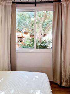 a bedroom with a bed and a large window at Suite4u in Eilat