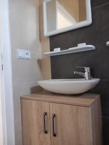 a bathroom with a sink and a mirror on a cabinet at Andalus Sunset in Tangier +21 photos