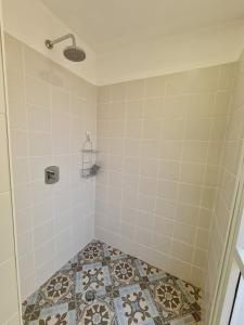 a bathroom with a shower with a tiled floor at Suite4u in Eilat