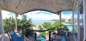 a balcony with a view of the ocean at Toddy by windy in Unawatuna +9 photos