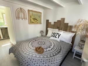 a bedroom with a bed with a comforter on it at Meerpaal 43 Bergen in Bergen