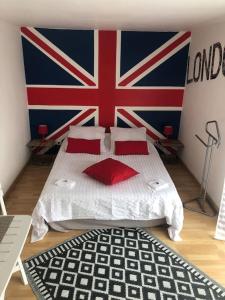 a bedroom with a bed with a british flag on the wall at Chez Titian Vue sur le Mont St Michel in Pontaubault