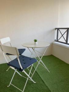 uma mesa e uma cadeira com uma planta sobre ela em Les terrasses de Port Nabat 2 em Vannes