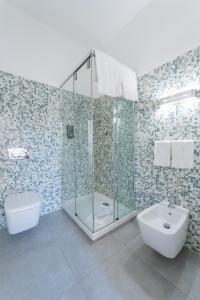 a bathroom with a shower and a toilet and a sink at Villa Mosca Charming House in Alghero