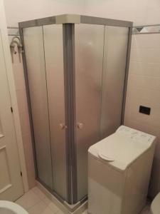 a bathroom with a toilet and a shower in it at La casetta rosa in Fano