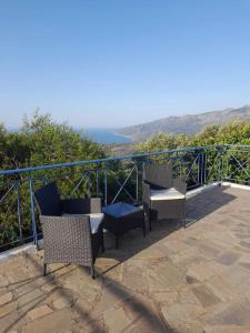 two chairs and a table on a balcony with a view at Frantato Seaview in Akamatra