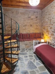 a bedroom with a spiral staircase next to a bed at Frantato Seaview in Akamatra