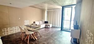 a living room with a couch and a table and chairs at Aveiro Sweet Nest in Aveiro