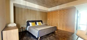 a bedroom with a bed and a wooden wall at Aveiro Sweet Nest in Aveiro
