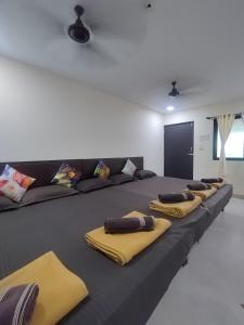 een kamer met een groot bed met gele kussens erop bij Opulence Beach Resort Awas, Alibaug in Alibaug