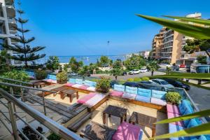 a view of a balcony with tables and chairs at Hotel Oasis in Sarandë