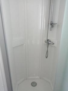 a shower stall with a toilet in a bathroom at Mobil-home (Clim)- Camping Narbonne-Plage 4* - 011 in Narbonne-Plage