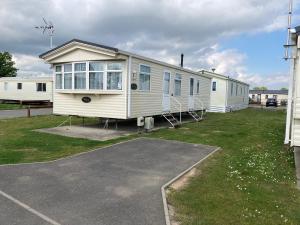 a mobile home is parked in a parking lot at Luxury 8 and 6 berth caravans in Jaywick Sands +37 photos