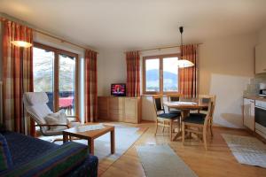 a living room with a table and a dining room at Reiterhof in Westendorf
