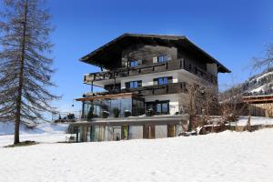 a building on top of a snow covered slope at Reiterhof in Westendorf