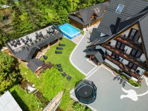 an aerial view of a house with a swimming pool at Leśny Dwór in Murzasichle
