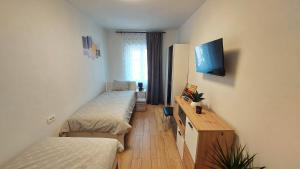 a dorm room with two beds and a desk at APARTMAN Zengg in Senj