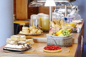 a table topped with lots of different types of food at Barcelona Century Hotel in Barcelona
