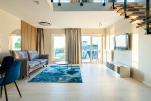 a living room with a couch and a table at Art Boulevard in Mrzeżyno